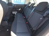 the back seats of a car are black and grey in color