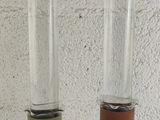 two glass vases that have been wrapped in leather