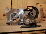 someone is using a circular saw to cut a piece of wood