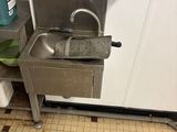 a sink in the corner of a kitchen with a faucet in it