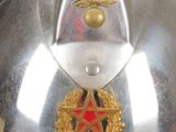 a silver helmet with a red star on it