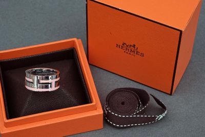 an orange box with a silver ring inside of it on a table