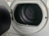 a white washer and dryer in a small room