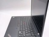 a laptop computer sitting on a table with a keyboard