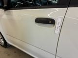 a small white car with a sticker on the side of it