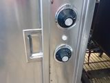 a large stainless steel oven that is in the kitchen