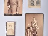 several old photos of men in military uniforms are on a wall