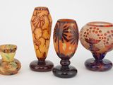 quatre vases posés sur une surface blanche