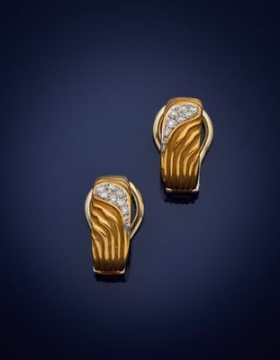a pair of gold and diamond earrings