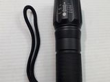 a close up of a flashlight on a white surface