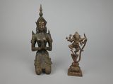 two bronze figurines of a woman holding a flower and a bird