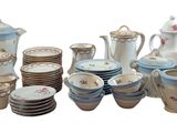 many different types of porcelain dishes and cups on the table