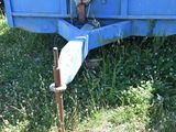 a blue trailer that is sitting in the grass