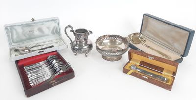 several silverware items including a teapot, spoons, and a box