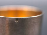 a close up of a metal cup on a table