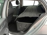 a car with the back door open with a blanket in the trunk