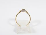 a gold and diamond ring with a square shaped diamond in the center