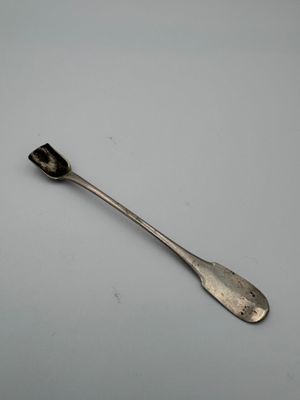 a close up of a spoon on a table with a white background