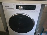 an image of a white washing machine in a kitchen