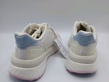 white and blue sneakers with a zipper on the sole