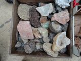 une boîte remplie de cailloux posée par terre