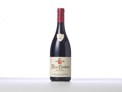 a bottle of red wine sitting on top of a table