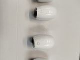four white hair dryers sitting on a white surface