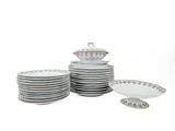 a stack of plates and bowls on a white table