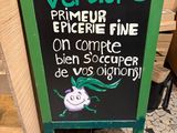a sign that says verdure primeur pickie fine on the sidewalk