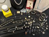 many different types of necklaces and bracelets on display
