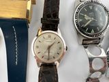 three different types of watches sitting on a table