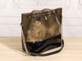 a close up of a purse on a table with a chain