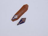 two pieces of leather with blue and white designs on them