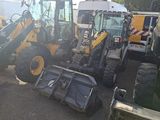 many construction vehicles that are parked in the parking lot