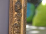 a reflection of a person in a mirror with a green apple in the background
