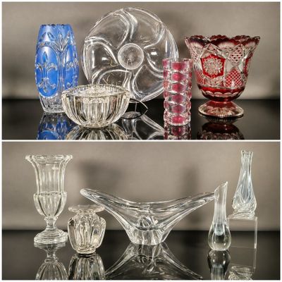 many different colored glass vases sitting on a table
