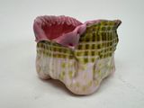 a small vase with a pink flower inside of it