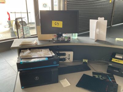 a desk with a computer, printer, and other electronics on it