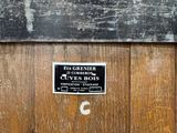 a wooden barrel that has a sign on it