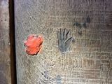a piece of wood that has a handprint on it