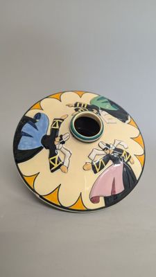 a ceramic candle holder with a cartoon design on it