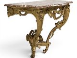 a gold console table with a marble top