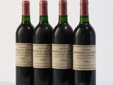 three bottles of red wine are lined up on a white surface