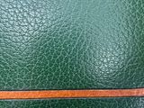 an image of a close up of a green leather wallet