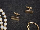 a lot of jewelry that is laying out on a table