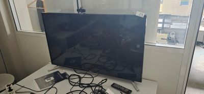 a flat screen tv sitting on top of a white table