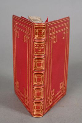 the book is red and gold with gold trimmings on it