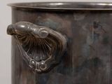 a large metal pot with a handle on it