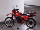 a red motorcycle that is parked in a parking garage