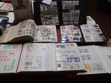 a lot of stamps on a table with a red table cloth